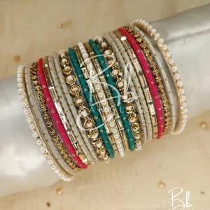 Experience the peak of elegance with the Diana set. This sophisticated stack features a stunning mix of three distinct shades, meticulously balanced with intricate gold spacers and classic pearl borders. Whether you are looking for the perfect Eid bangles or a standout bridesmaid gift, the Diana set offers a versatile, high-fashion look that elevates any formal or festive ensemble.