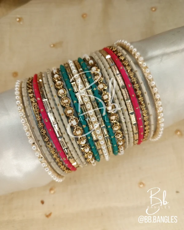 Experience the peak of elegance with the Diana set. This sophisticated stack features a stunning mix of three distinct shades, meticulously balanced with intricate gold spacers and classic pearl borders. Whether you are looking for the perfect Eid bangles or a standout bridesmaid gift, the Diana set offers a versatile, high-fashion look that elevates any formal or festive ensemble.