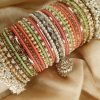 Gulabi is an exclusive handcrafted bangle set featuring a soft blend of mint green, blush pink, and champagne tones. Designed with intricate kundan kary, pearl detailing, teardrop stone accents, and a statement jhumki charm, this set is beautifully finished with luxurious shahi gajray on both ends for a complete bridal look.Perfect for nikkah, engagement, mehndi, walima, and festive occasions. Base Bangles: High-quality brass alloy Kary Work: Copper alloy Stones & Pearls: Non-precious, premium quality stones and artificial pearls Durable, lightweight, and crafted for comfortable long wear.