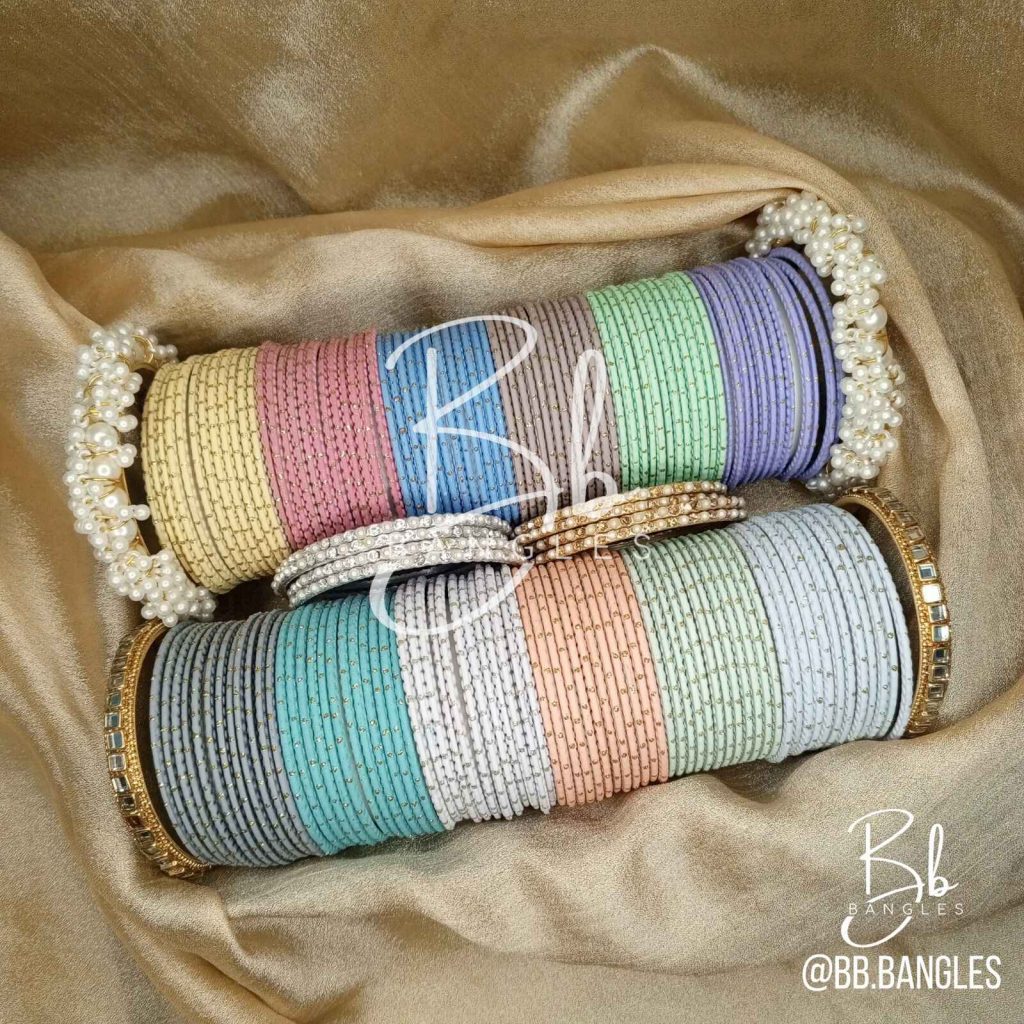 A Selection of 12 Bright Colors alongwith: A pair of Gajra Bangles, A pair of Kundan Karay, 4 Golden thin Pearl and Nug Karay, 4 Silver think Pearl and Nug Karay