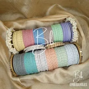 A Selection of 12 Bright Colors alongwith: A pair of Gajra Bangles, A pair of Kundan Karay, 4 Golden thin Pearl and Nug Karay, 4 Silver think Pearl and Nug Karay
