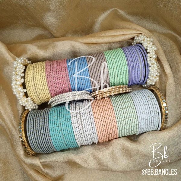 A Selection of 12 Bright Colors alongwith: A pair of Gajra Bangles, A pair of Kundan Karay, 4 Golden thin Pearl and Nug Karay, 4 Silver think Pearl and Nug Karay