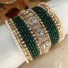 Nilofar is one of the best-selling, must-have handcrafted bangle set available in a wide range of color options, ensuring a perfect match with for any given outfit.It is crafted with multiple color tones to create a high-impact, sophisticated affect. The design is beautifully detailed with a wide Nug Kara, multiple pearl and nug chori, Built with a durable brass alloy base, every piece is meticulously hand-polished to ensure smooth edges and a comfortable, lightweight feel that lasts through long celebrations.