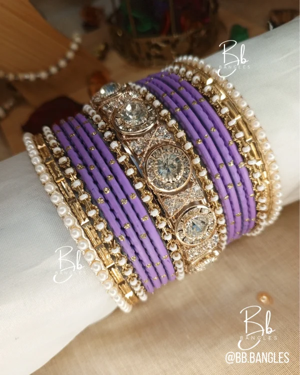 Nilofar is one of the best-selling, must-have handcrafted bangle set available in a wide range of color options, ensuring a perfect match with for any given outfit.It is crafted with multiple color tones to create a high-impact, sophisticated affect. The design is beautifully detailed with a wide Nug Kara, multiple pearl and nug chori, Built with a durable brass alloy base, every piece is meticulously hand-polished to ensure smooth edges and a comfortable, lightweight feel that lasts through long celebrations.