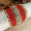 Nilofar is one of the best-selling, must-have handcrafted bangle set available in a wide range of color options, ensuring a perfect match with for any given outfit.It is crafted with multiple color tones to create a high-impact, sophisticated affect. The design is beautifully detailed with a wide Nug Kara, multiple pearl and nug chori, Built with a durable brass alloy base, every piece is meticulously hand-polished to ensure smooth edges and a comfortable, lightweight feel that lasts through long celebrations.