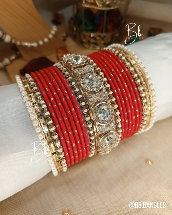Nilofar is one of the best-selling, must-have handcrafted bangle set available in a wide range of color options, ensuring a perfect match with for any given outfit.It is crafted with multiple color tones to create a high-impact, sophisticated affect. The design is beautifully detailed with a wide Nug Kara, multiple pearl and nug chori, Built with a durable brass alloy base, every piece is meticulously hand-polished to ensure smooth edges and a comfortable, lightweight feel that lasts through long celebrations.