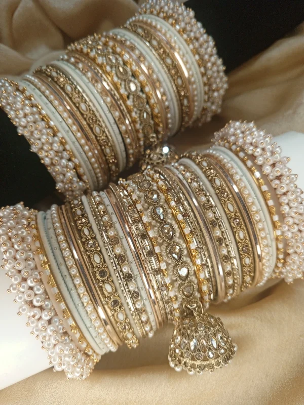 Perfect bangles for your Nikkah event White and Golden: . Adorned with an original reverse American Diamond Jhumki Kara, a pair of Premium Shahi Gajray with Golden Asscent and a pair of Reverse American Diamond Tear Drop Karay, this design is as classic as it gets. With multi thin Karay in Pearl, Crystals and wire work, accompanied by Matt Dot Glitter and Glossy Bangles in a range of white and golden , this set is ideal for nikkah, valima ceremonies, family gatherings, or special invitations for brides, bridesmaids, and graceful mothers alike