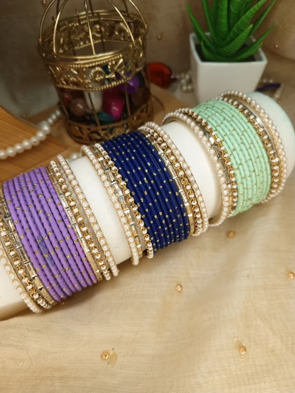 Add a touch of modern sophistication to your festive wardrobe with our Chic Collection. These sets feature a solid colors Matt Dot litter Bangles, accomapnied by thin Pearl Karay and Kut Pearl Karay. Whether you're dressing up for Eid celebrations or looking for the perfect bridesmaid gift, these sets offer a sleek, high-fashion alternative to traditional heavy jewelry