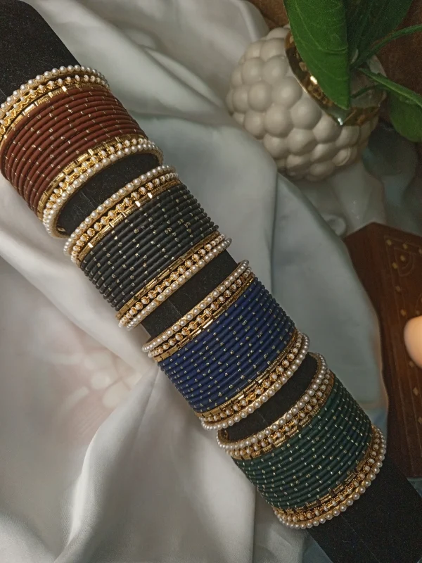 Add a touch of modern sophistication to your festive wardrobe with our Chic Collection. These sets feature a solid colors Matt Dot litter Bangles, accomapnied by thin Pearl Karay and Kut Pearl Karay. Whether you're dressing up for Eid celebrations or looking for the perfect bridesmaid gift, these sets offer a sleek, high-fashion alternative to traditional heavy jewelry