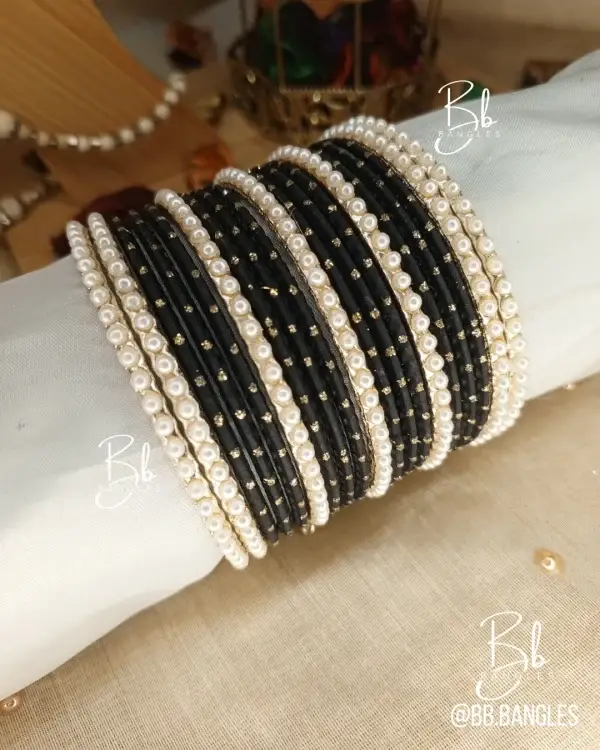 Elevate your festive ensemble with our most-trending Elara set. Perfectly balancing tradition with a clean, sophisticated aesthetic, this set is an essential for your Eid bangles collection. Featuring a classic dozen-bangle core accented by our signature 7 pearl chori dividers, it offers a refined sparkle that transitions effortlessly from formal weddings to intimate