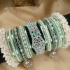 Exclusive Mint Green & Silver Set ✨Elevate your bridal or festive look with our exquisite mint green and silver bangle set! Featuring a center mint green & silver kara, paired with two teardrop kundan jhumki karas and pearl-accented silver Shahi Gajray, this set blends elegance and tradition perfectly.Perfect for weddings, valima ceremonies, and special celebrations.