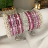 Make a statement with our stunning Falsai-toned bangle set! Featuring a center Falsai & silver kara, paired with two teardrop kundan jhumki karas and pearl-accented silver Shahi Gajray, this set brings elegance and tradition together in perfect harmony. Ideal for weddings, valima ceremonies, and special celebrations.