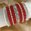 Make a bold and graceful statement with the Mirha set. This captivating stack features a deep crimson red base contrasted against brilliant, high-shine silver accents. Designed to enhance your look with a touch of royal flair, it combines the shimmer of silver mirror-work karas with delicate pearl detailing. Whether it’s for a bride, a festive Eid celebration, or a premium bridesmaid gift, the Mirha set is the ultimate accessory for those who love timeless elegance with a modern silver edge.